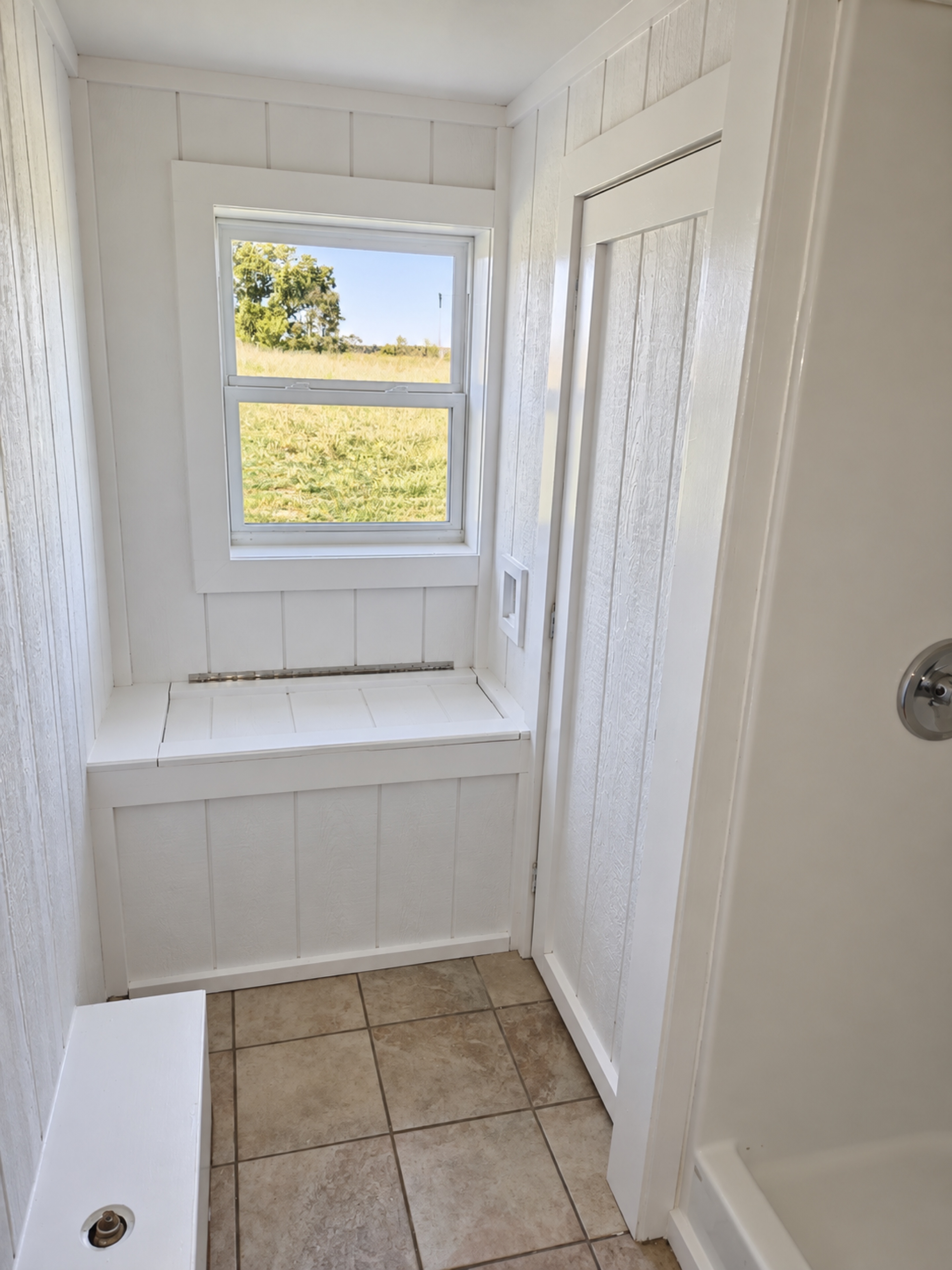 Finished basement utility and storage area with window