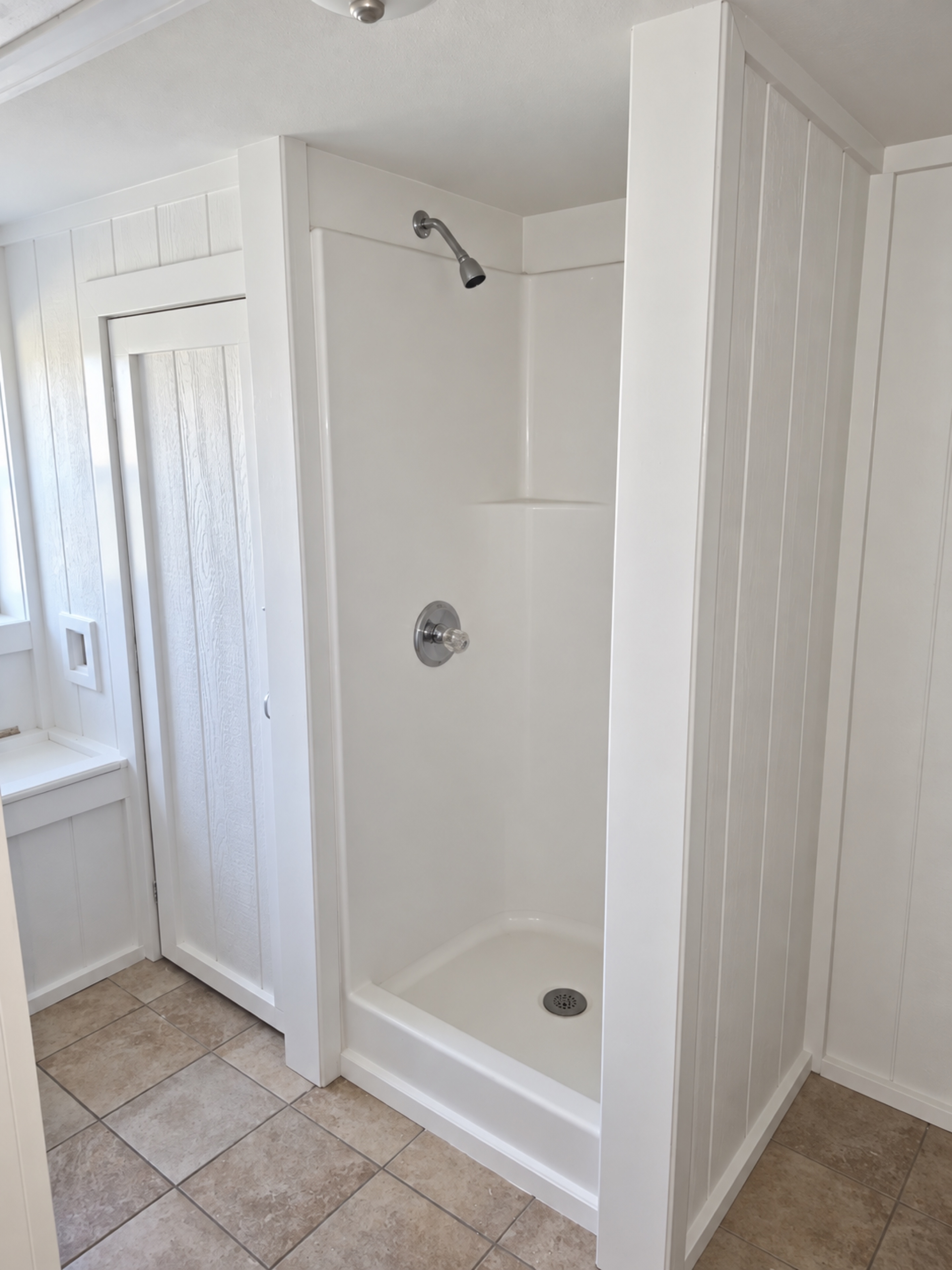 Finished walk-in shower with white surround
