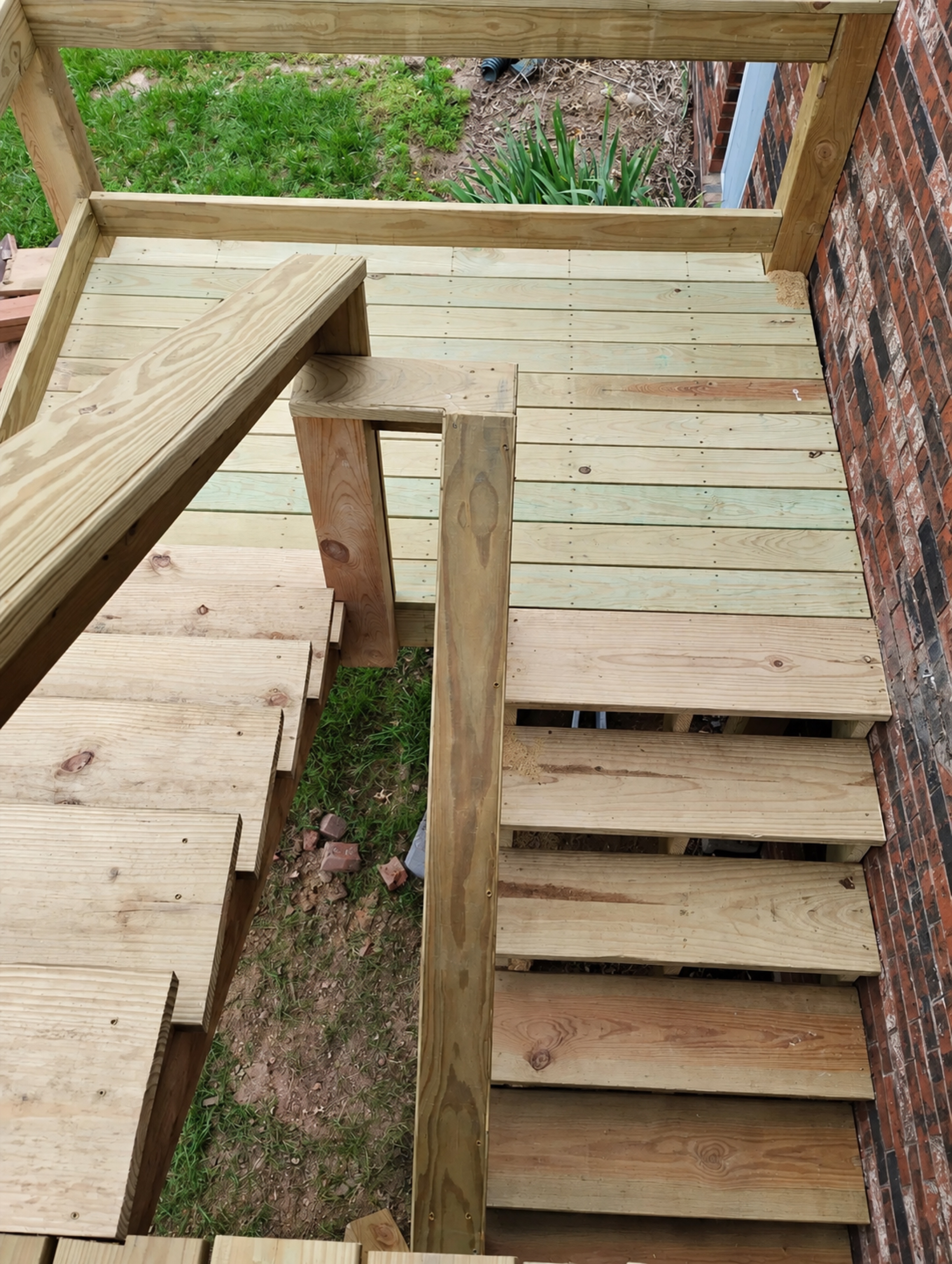 New intermediate wood landing connecting two exterior stair runs