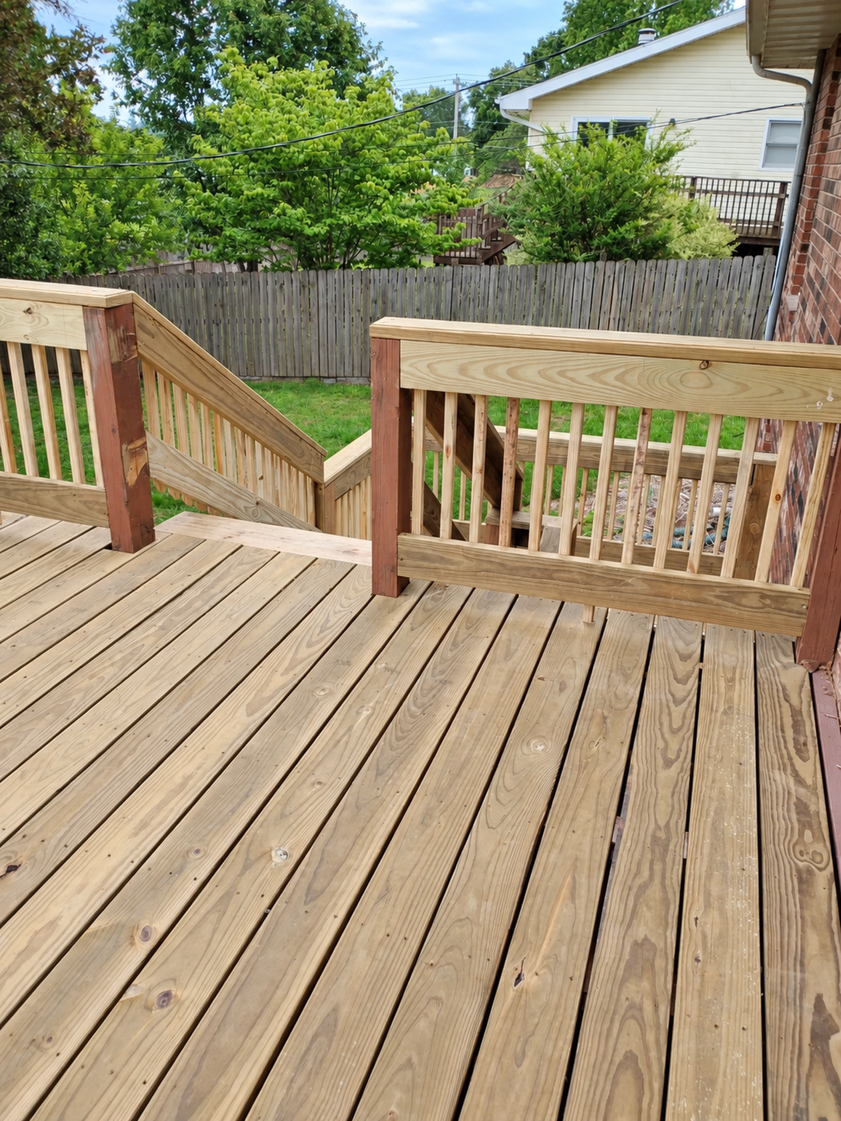 Completed elevated deck with new decking, stairs and railings