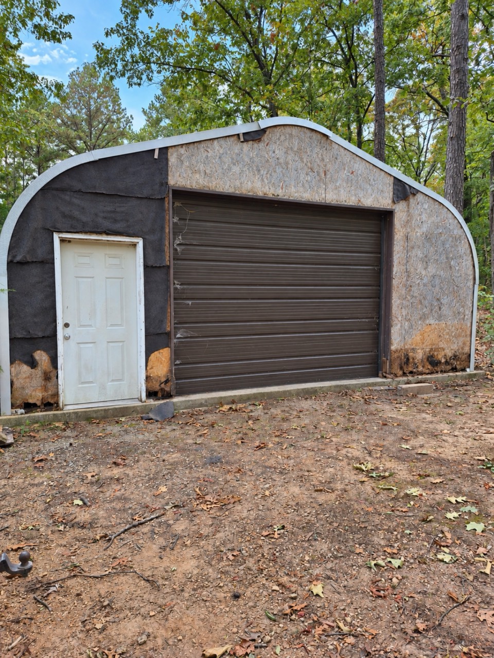 Before: garage front with worn, exposed sheathing